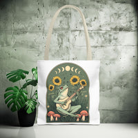 Load image into Gallery viewer, Whimsical Frog Guitarist Tote Bag - Vintage Style Sunflower Mushrooms Moon Phase Design, Music Lover Gift, Boho Chic Shoulder Bag, Nature
